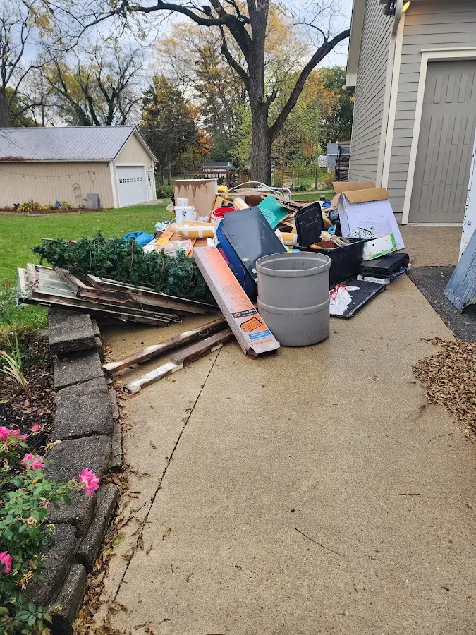 Dumpster being loaded with debris for Estate Cleanout Dumpster Rental in Lake Elmo